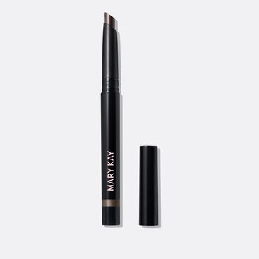 The Shimmer Eye Shadow Stick in shade Midnight Galaxy stands on a white background with the cap off, clearly showing the slanted tip and shade.  